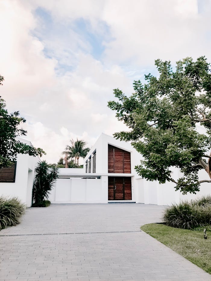 our-services-1 Contemporary minimalist home exterior with lush landscaping and open driveway.